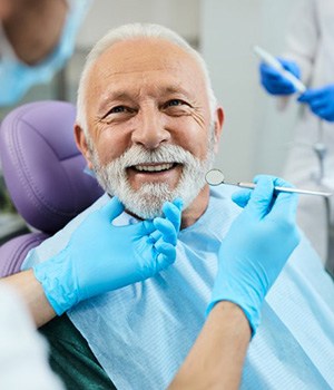 a patient smiling while visiting his dentist
