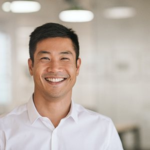 Man in white button-up shirt smiling