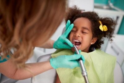 Dentist working on child patient.